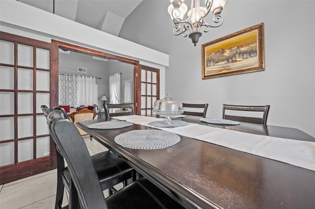 dining room with high vaulted ceiling, a chandelier, and french doors