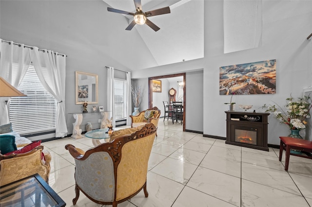 living room featuring ceiling fan and high vaulted ceiling