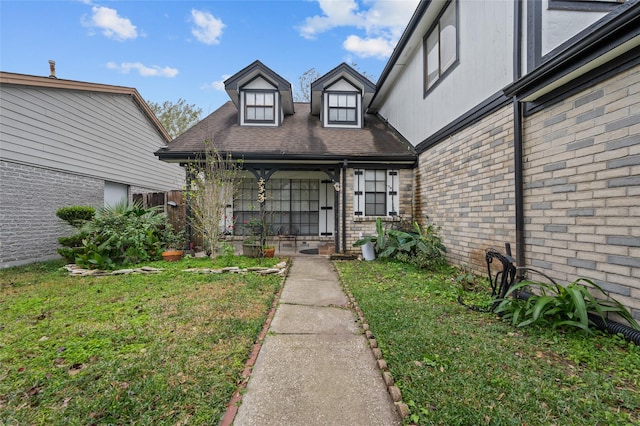 property entrance with a lawn