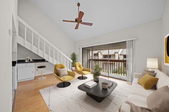 living room featuring vaulted ceiling, ceiling fan, and light hardwood / wood-style floors