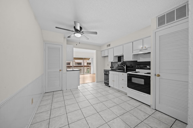 kitchen with white cabinetry, light tile patterned floors, ceiling fan, electric range oven, and a textured ceiling