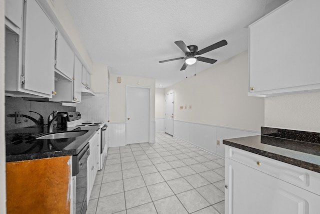 kitchen featuring dishwasher, white cabinets, electric range, and sink