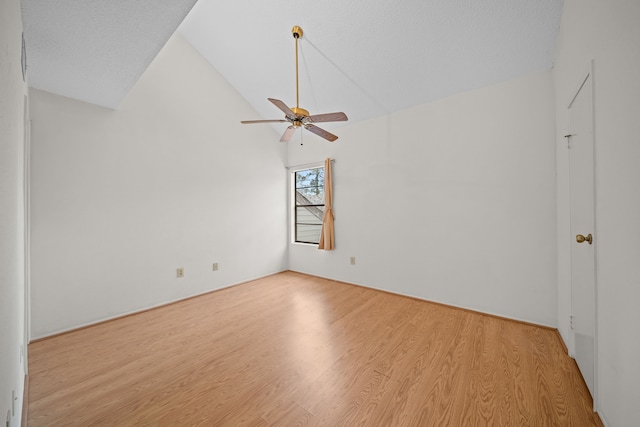 spare room with light wood-type flooring, ceiling fan, and lofted ceiling