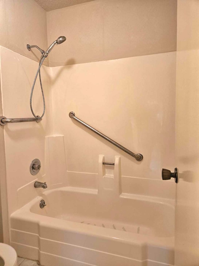 bathroom featuring bathing tub / shower combination and tile patterned floors