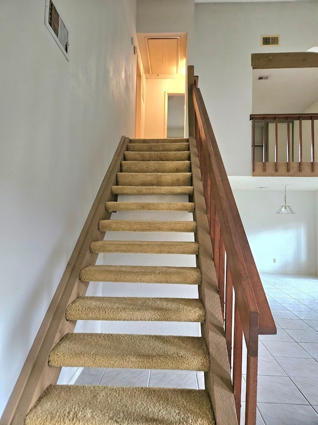 stairway with tile patterned flooring