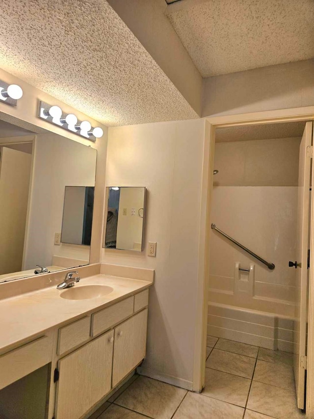 bathroom featuring a textured ceiling, tile patterned floors, and vanity