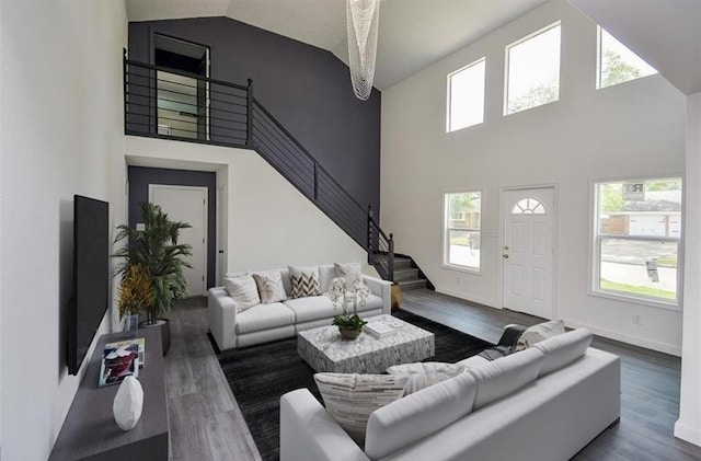 living room featuring high vaulted ceiling and dark hardwood / wood-style floors