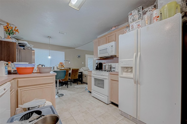 kitchen with light tile patterned floors, light brown cabinetry, white appliances, and pendant lighting