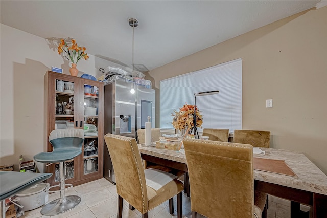 dining area featuring light tile patterned floors