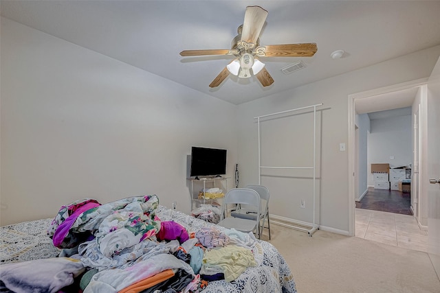 bedroom with ceiling fan and light carpet