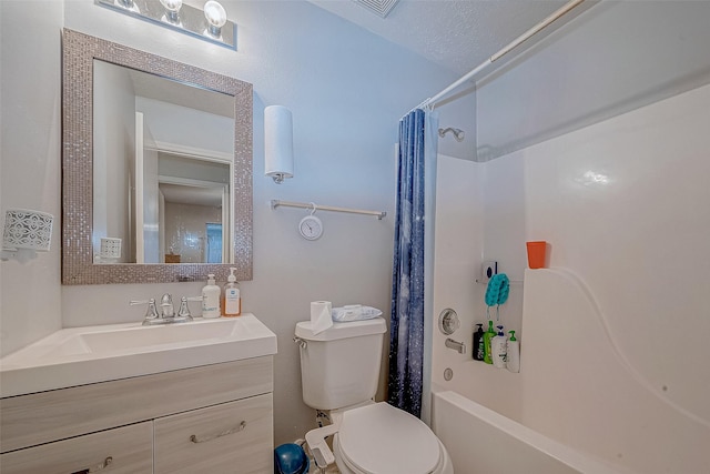 full bathroom featuring toilet, a textured ceiling, shower / tub combo, and vanity