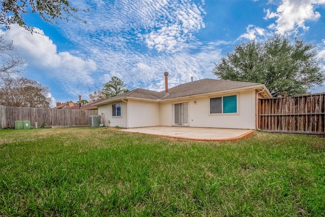 back of property with a patio area, a lawn, and central air condition unit