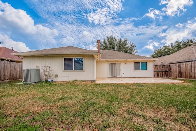 rear view of property with central AC, a yard, and a patio