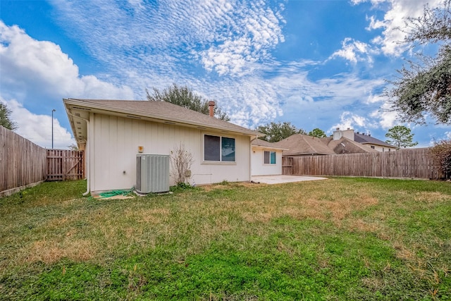 back of property featuring cooling unit, a patio, and a yard