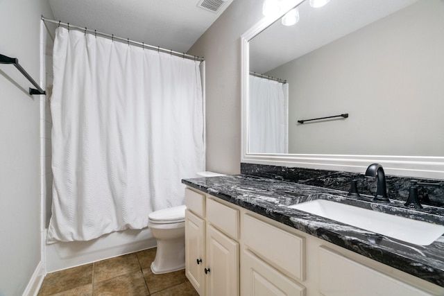 full bathroom featuring shower / bath combo, vanity, tile patterned floors, and toilet