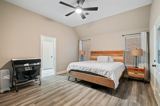 bedroom featuring ceiling fan, vaulted ceiling, and wood-type flooring