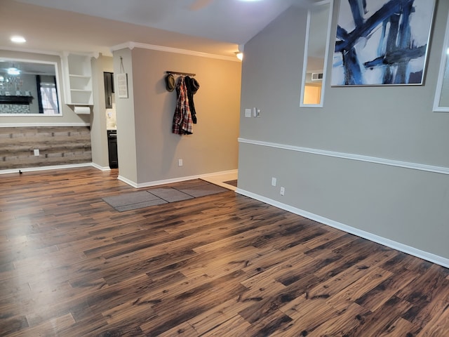 unfurnished room with dark wood-type flooring and crown molding