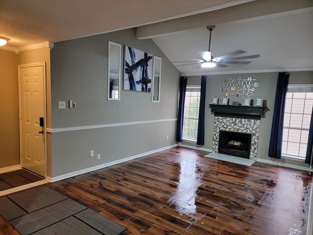 unfurnished living room with dark wood-type flooring, ceiling fan, a fireplace, and vaulted ceiling with beams