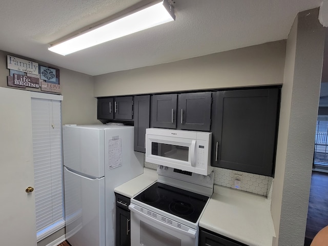 kitchen with white appliances and a textured ceiling