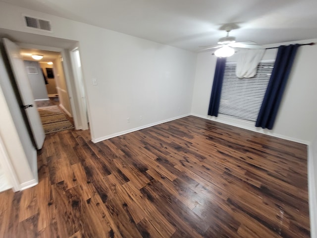 spare room with dark hardwood / wood-style floors and ceiling fan