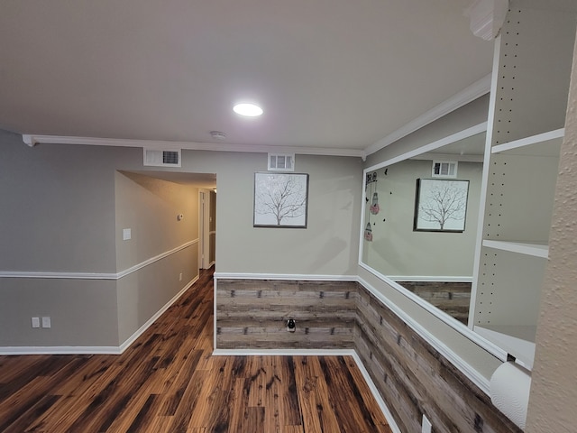 interior space with dark wood-type flooring and ornamental molding