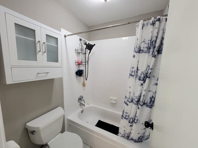 bathroom with shower / tub combo, toilet, and a textured ceiling