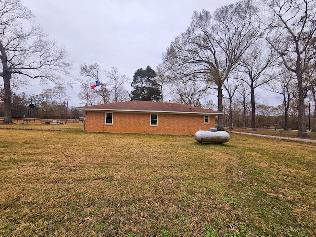 view of side of home with a lawn