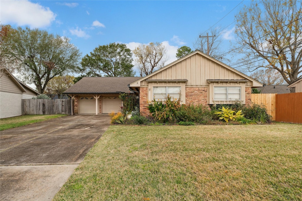 single story home featuring a garage and a front yard