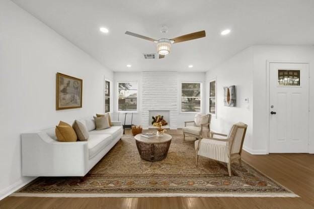 living room featuring hardwood / wood-style flooring and ceiling fan