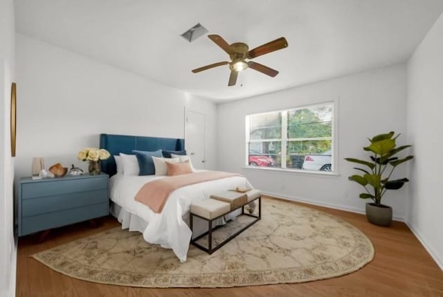 bedroom with wood-type flooring and ceiling fan