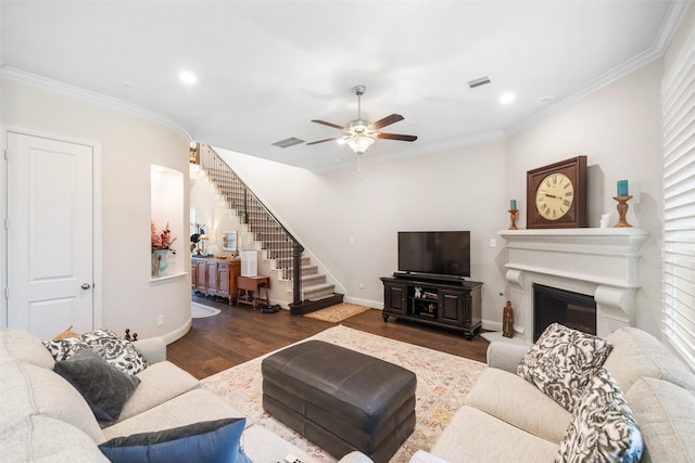 living room with ornamental molding, dark hardwood / wood-style floors, and ceiling fan