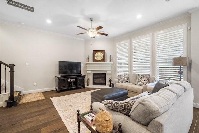 living room featuring ornamental molding, ceiling fan, and dark hardwood / wood-style flooring