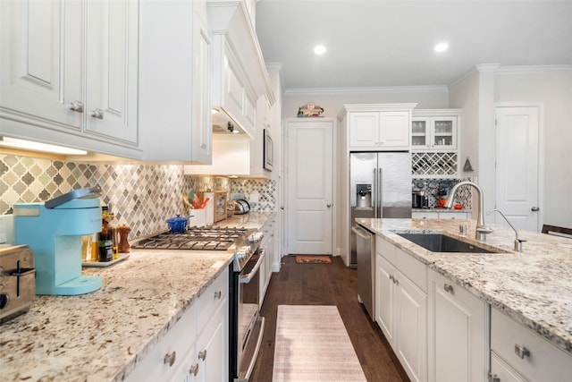 kitchen with white cabinetry, sink, ornamental molding, and stainless steel appliances