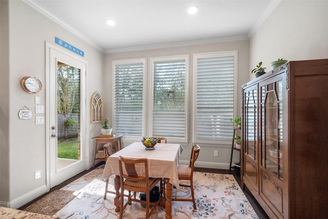 dining space featuring crown molding and light hardwood / wood-style floors