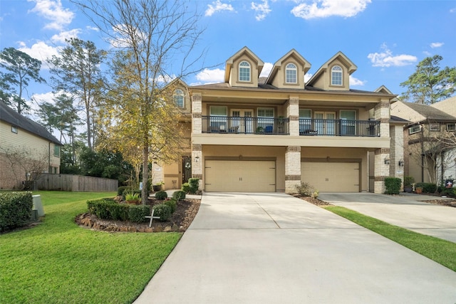 view of front of home featuring a garage, a balcony, and a front yard