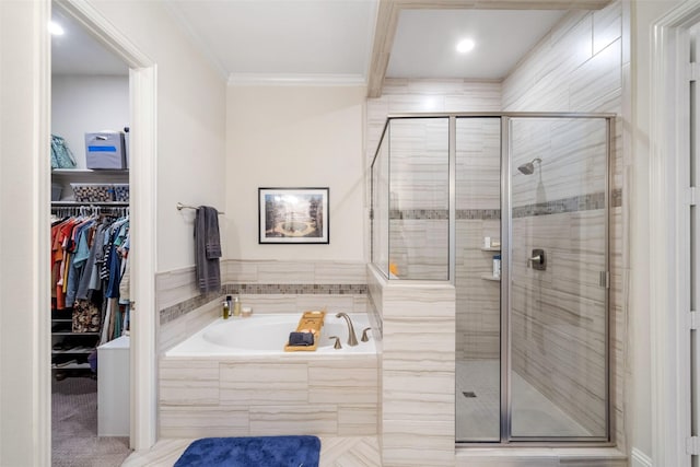 bathroom with ornamental molding and separate shower and tub