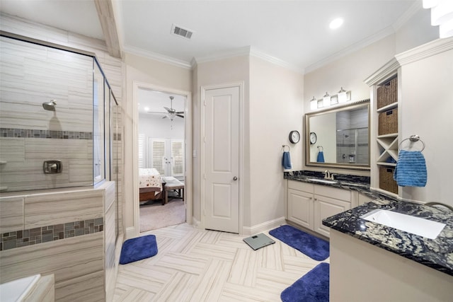 bathroom featuring crown molding, a tile shower, vanity, and ceiling fan