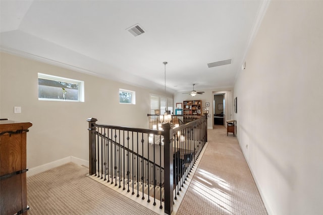 stairway with crown molding, carpet flooring, and ceiling fan