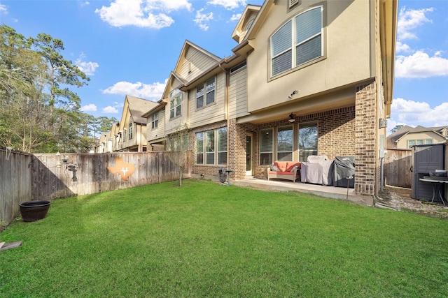 back of house featuring a patio, a yard, and ceiling fan