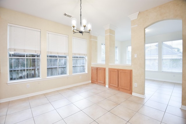 unfurnished dining area featuring light tile patterned floors and a chandelier