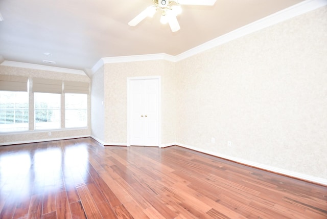 unfurnished room featuring ceiling fan, ornamental molding, and hardwood / wood-style flooring