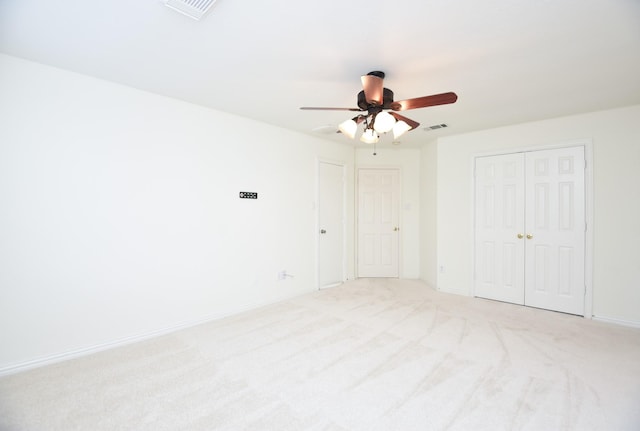 interior space featuring ceiling fan and light colored carpet