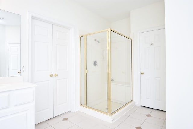 bathroom featuring walk in shower, vanity, and tile patterned floors