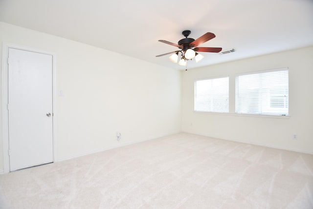 unfurnished room with ceiling fan and light colored carpet