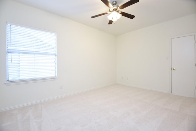 spare room featuring ceiling fan and light colored carpet