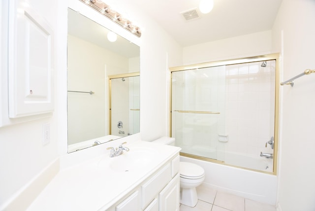 full bathroom featuring toilet, tile patterned floors, vanity, and enclosed tub / shower combo