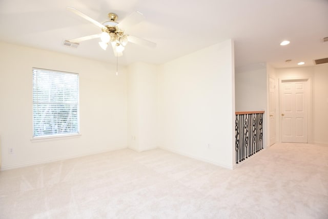 carpeted empty room featuring ceiling fan