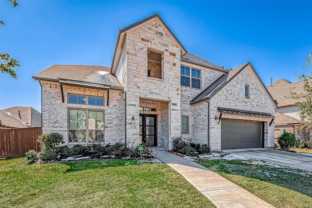 view of front of home featuring a garage and a front yard