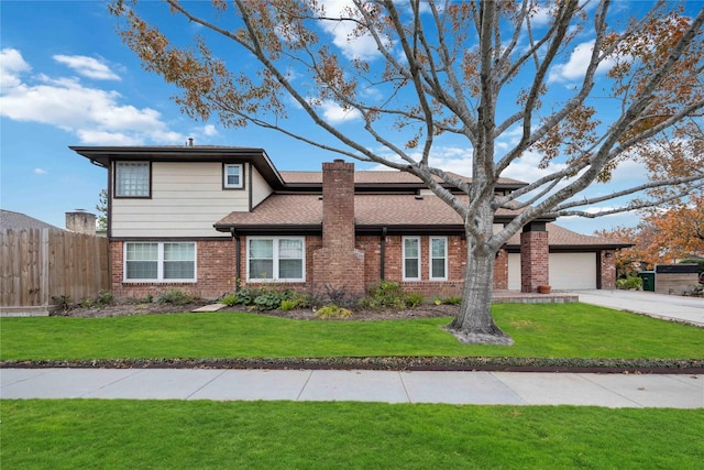 view of front of house with a front lawn and a garage