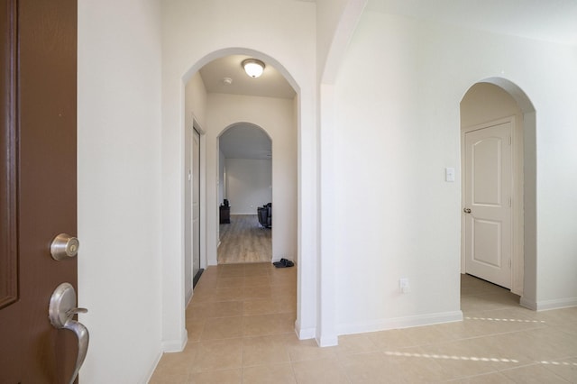 corridor featuring light tile patterned floors